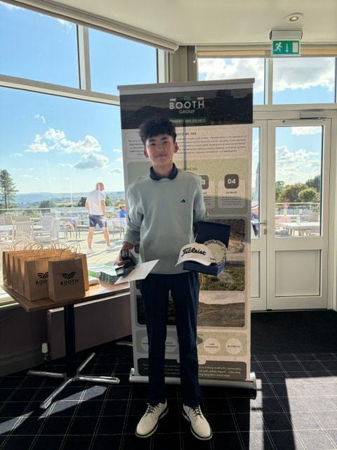 Junior golfer with Titleist prize at the Booth Group stand