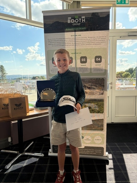 Junior golfer with Titleist prize at the Booth Group stand